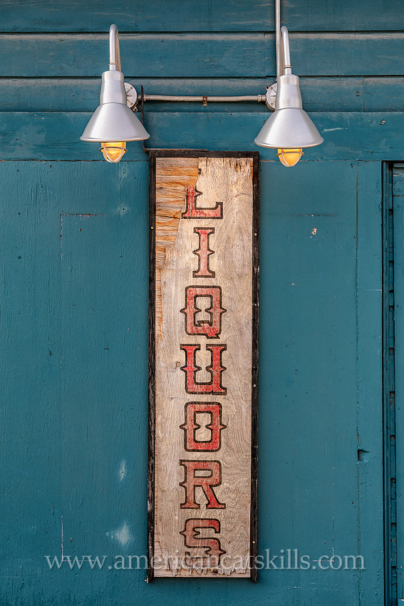Photograph of a sign that says "liquors" in the northern Catskills village of Tannersville, New York.