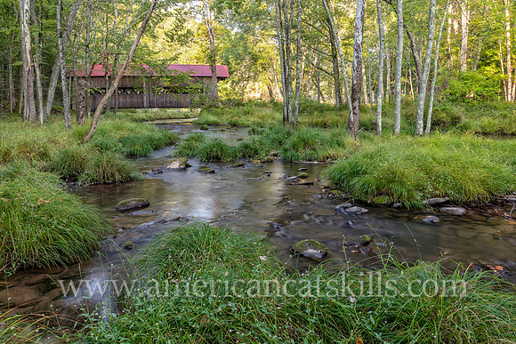 Photograph of the Ashokan-Turnwood Covered Bridge, located at the Ashkokan Center in the Catskills hamlet of Olivebridge, New York.
