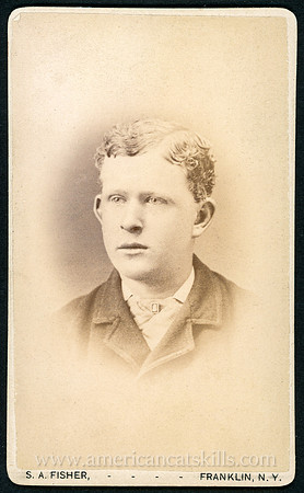 Portrait photograph of a young man in a suit taken by photographer S. A. Fisher of Franklin, New York.