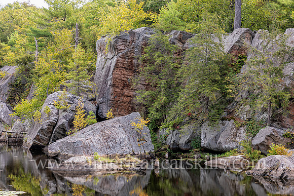 Photograph of rocky cliffs on the pond at the John Burroughs Nature Sanctuary in West Park, New York.