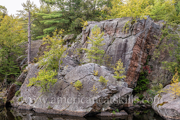 Photograph of rocky cliffs on the pond at the John Burroughs Nature Sanctuary in West Park, New York.