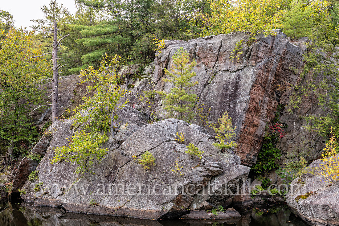 Photograph of rocky cliffs on the pond at the John Burroughs Nature Sanctuary in West Park, New York.