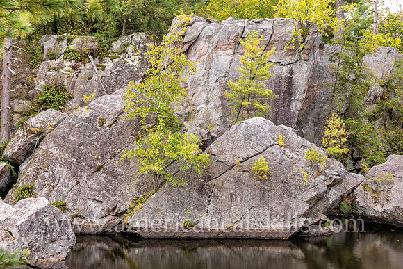 Photograph of rocky cliffs on the pond at the John Burroughs Nature Sanctuary in West Park, New York.