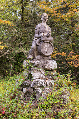 Photograph of a sculpture of a man sitting on top of a keg at the John Burroughs Nature Sanctuary in West Park, New York.