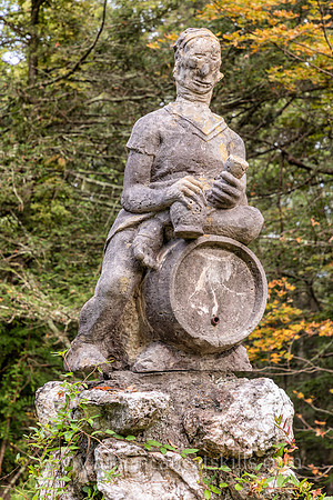 Photograph of a sculpture of a man sitting on top of a keg at the John Burroughs Nature Sanctuary in West Park, New York.