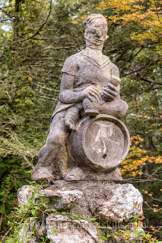 Photograph of a sculpture of a man sitting on top of a keg at the John Burroughs Nature Sanctuary in West Park, New York.