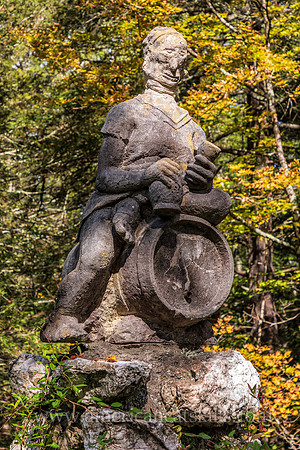 Photograph of a sculpture of a man sitting on top of a keg at the John Burroughs Nature Sanctuary in West Park, New York.