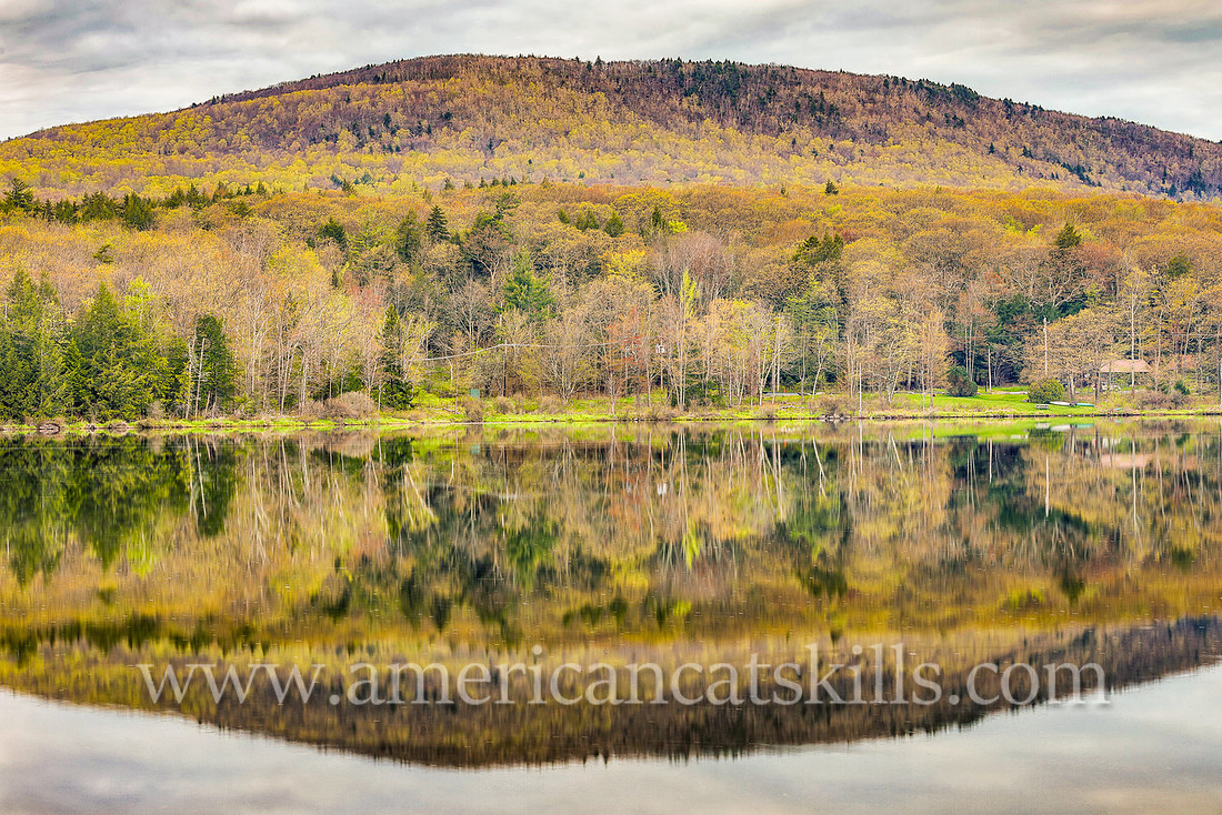 Photograph of the mountain overlooking the lake in springtime at North-South Lake in Haines Falls, New York.