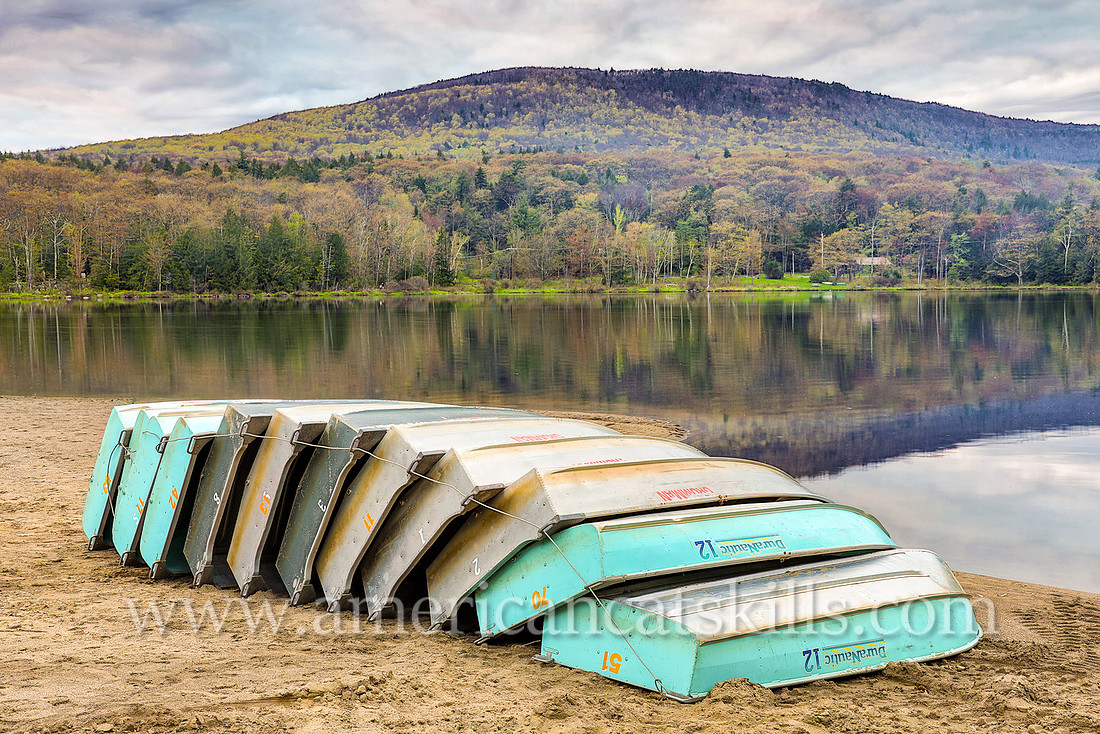 Photograph of rowboats on the beach in springtime at North-South Lake in Haines Falls, New York.