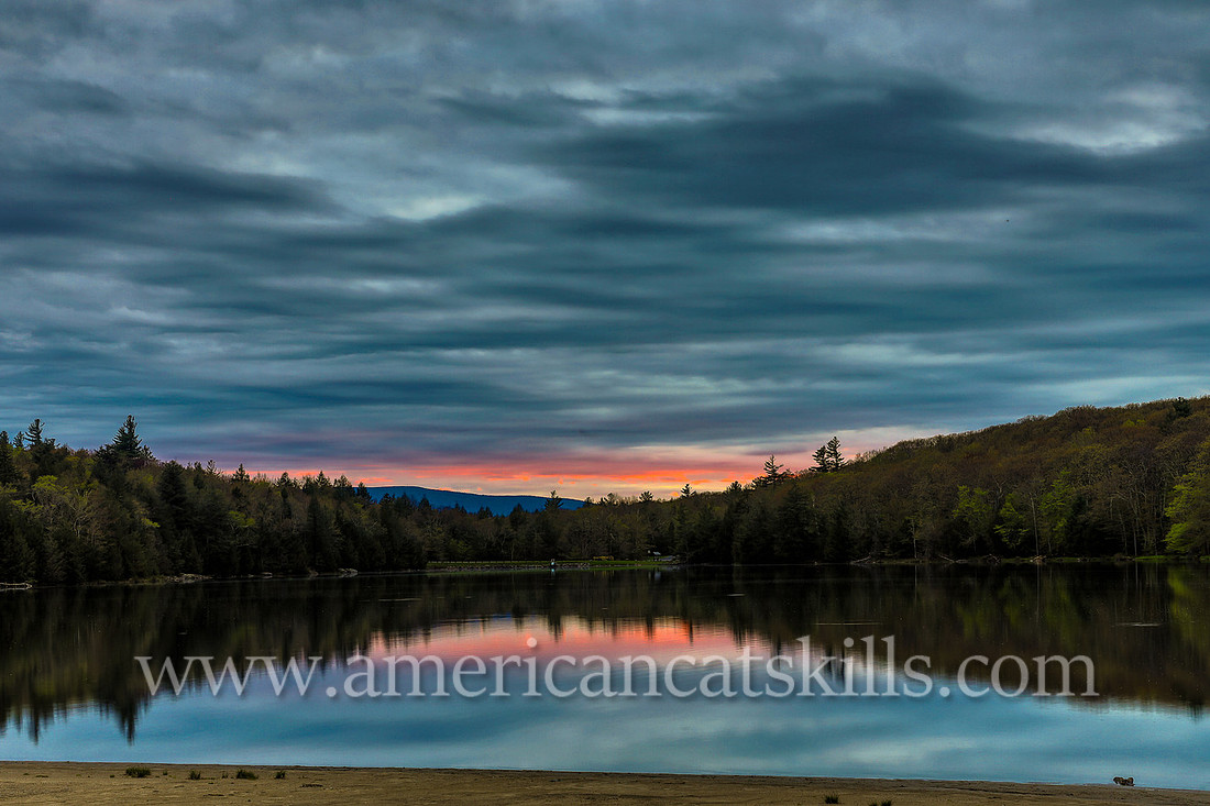 Photograph of the receding evening light over the lake at North-South Lake in Haines Falls, New York.