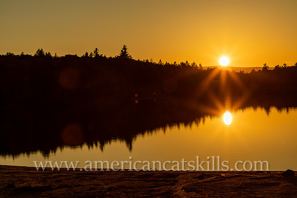 Photograph of the sunset over the lake at North-South Lake in Haines Falls, New York.