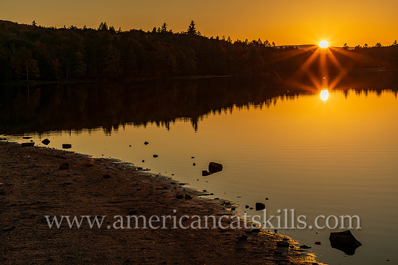 Photograph of the sunset over the lake at North-South Lake in Haines Falls, New York.