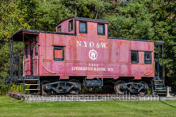 Photograph of the red O&W caboose car located off exit 96 of Route 17 at the entrance of Livingston Manor, New York.
