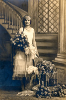 Portrait of a young woman holding flowers taken by the Pennington Studio of Kingston, New York.