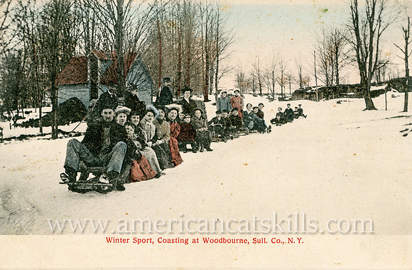 Vintage postcard titled "Winter Sport, Coasting at Woodbourne, Sull. Co., N. Y." showing a large group of people sledding down a hill.