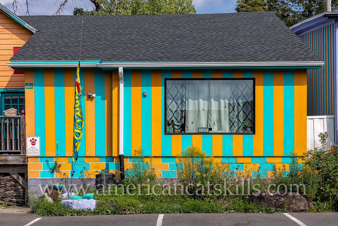 Photograph of a small building with painted stripes in the northern Catskills village of Tannersville, New York.
