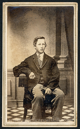 Portrait of a young man seated, taken by photographer B. F. Gilbert of Delhi, New York.