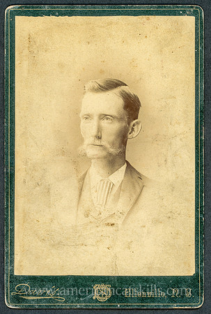 Portrait of a man in a suit by photographer Winfield S. Davis of Ellenville, New York.