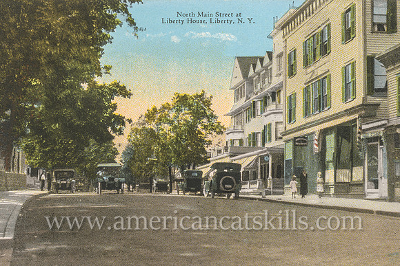 Vintage postcard from photographer Otto Hillig showing North Main Street in the village of Liberty in Sullivan County, New York.
