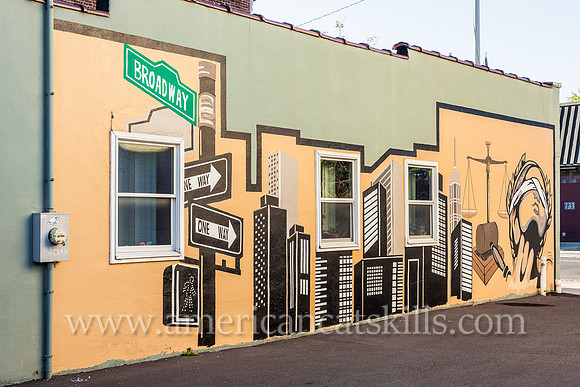 The midtown Kingston mural known as Justice, appropriately located on the side wall of a legal practice, depicts Lady Justice, the scales of justice and a city skyline.