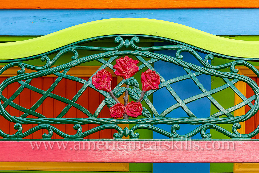 Photograph of a colorful bench with metal flowers in the northern Catskills village of Tannersville, New York.