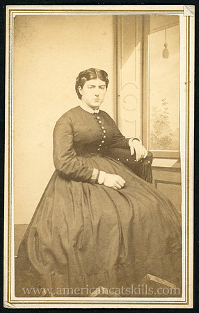 Portrait of a young woman seated, taken by photographer B. F. Gilbert of Delhi, New York.
