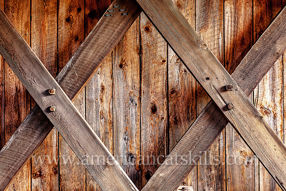 The Millbrook Covered Bridge demonstrates the Town Lattice truss, which includes the use of wooden “tree nails,” or trunnels, to connect the diagonal timbers used to hold the bridge together.