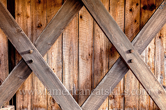 The Millbrook Covered Bridge demonstrates the Town Lattice truss, which includes the use of wooden “tree nails,” or trunnels, to connect the diagonal timbers used to hold the bridge together.