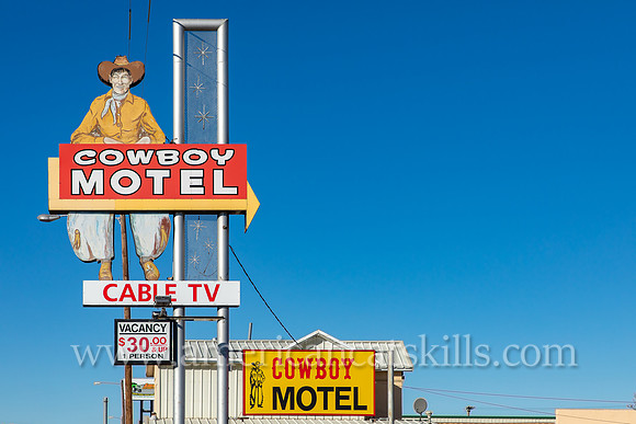 Vintage sign depicting an old-fashioned cowboy while advertising for the Cowboy Motel, an historic motor court located along Route 66 (East Amarillo Boulevard) in the city of Amarillo, Texas.