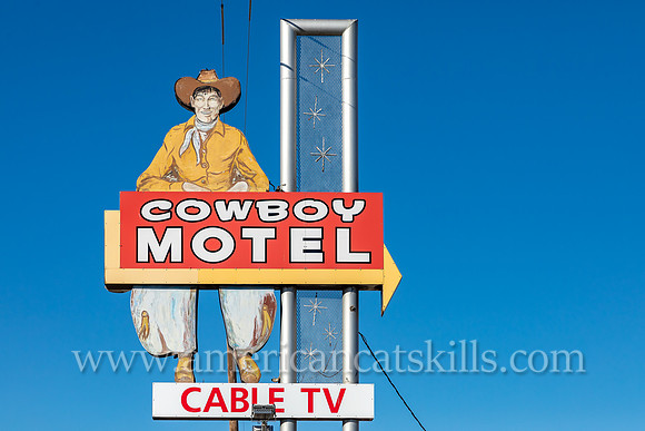Vintage sign depicting an old-fashioned cowboy while advertising for the Cowboy Motel, an historic motor court located along Route 66 (East Amarillo Boulevard) in the city of Amarillo, Texas.