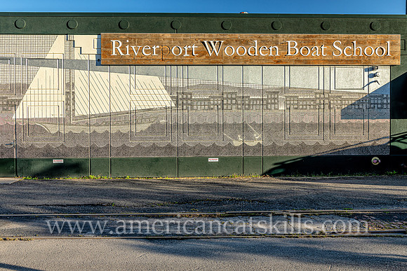 Mural by Matthew Pleva at the Riverport Wooden Boat School in the Rondout District of Kingston, New York depicting the Rondout Lighthouse, buildings of the Strand, a Viking ship, small boat fishermen