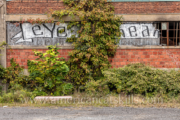 Graffiti of the words “Eye” and “Ear” on the outside of the abandoned factory of B. Millens & Sons in the Rondout District of Kingston, New York.