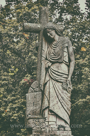 Sculpture of a woman carrying a cross at the Montrepose Cemetery in Kingston, New York.
