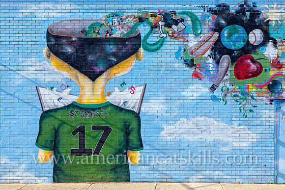 The vibrant and imaginative mural known as Fishbone, painted by Eugene Stetz, Jr., adorns the side of People’s Place in midtown Kingston.