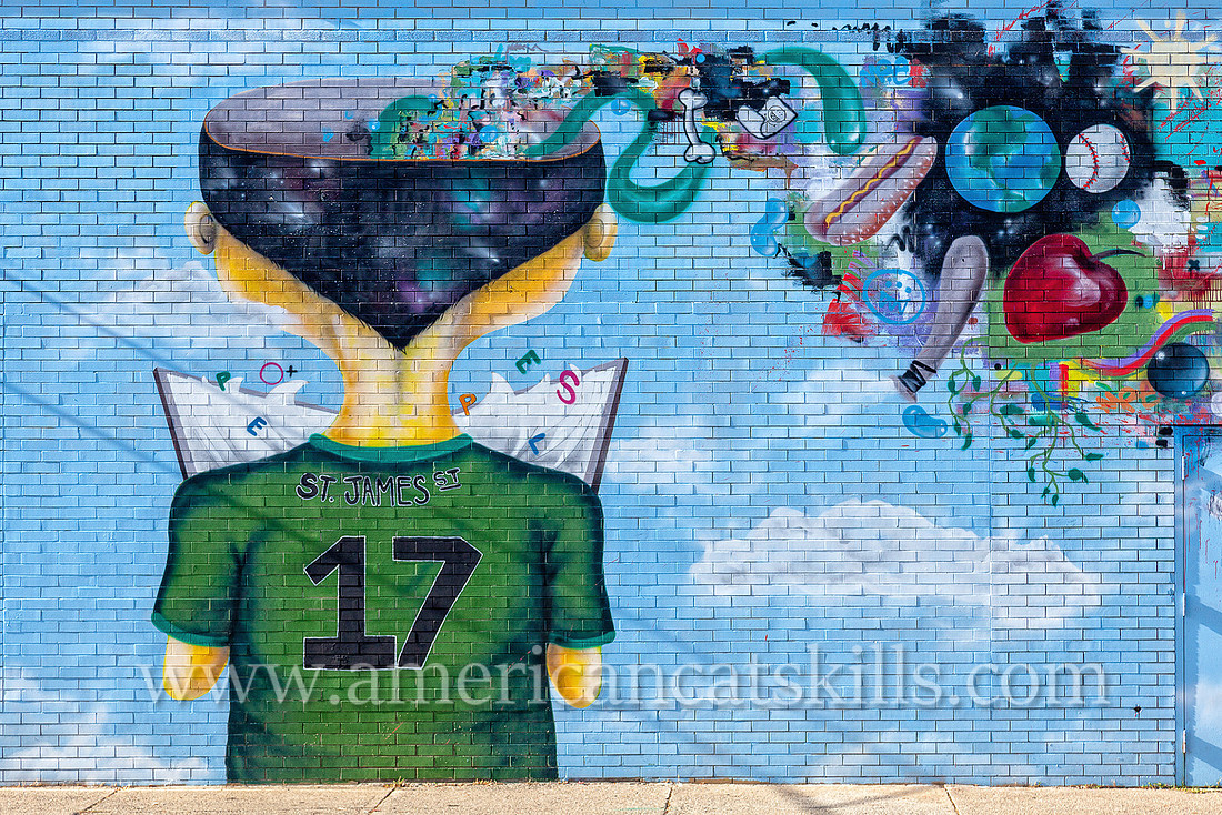 The vibrant and imaginative mural known as Fishbone, painted by Eugene Stetz, Jr., adorns the side of People’s Place in midtown Kingston.