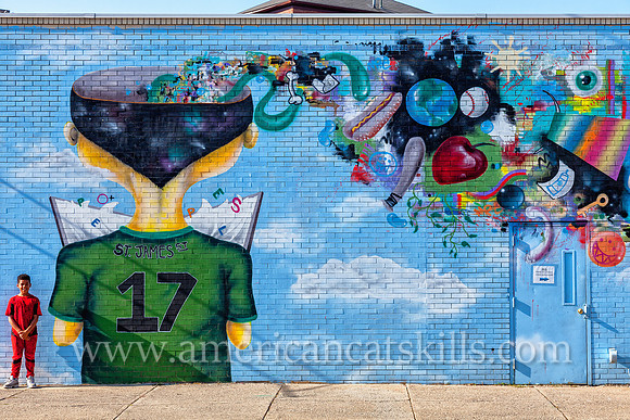 The vibrant and imaginative mural known as Fishbone, painted by Eugene Stetz, Jr., adorns the side of People’s Place in midtown Kingston.