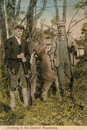 Vintage Catskills postcard depicting two young men with their deer.