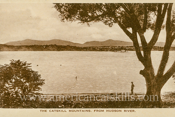 Vintage postcard with a view of a man standing on the shore of the Hudson River with the Catskill Mountains looming in the background.