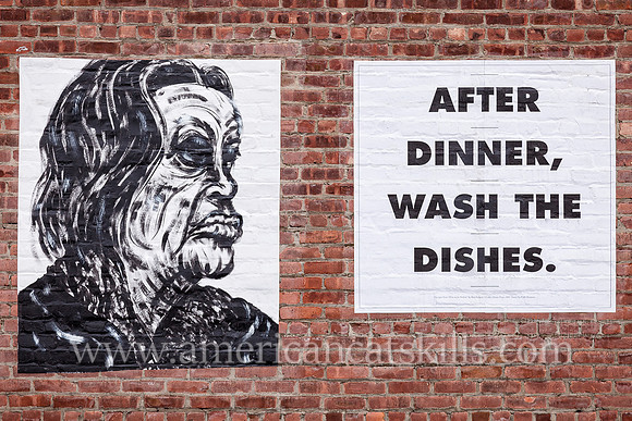 Mural of an angry man with the words “After Dinner, Wash the Dishes”; located on the outside wall of the former Standard Furniture business in the Stockade District of Kingston, New York.