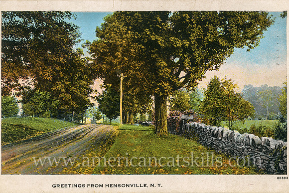 A dirt road makes its way through the countryside in this vintage postcard titled “Greetings from Hensonville, N.Y.”
