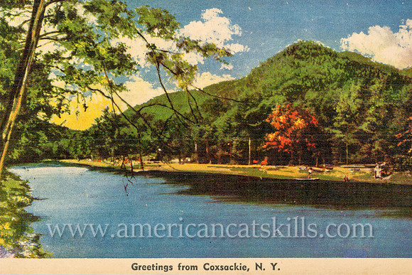 A quiet river scene with a lushly vegetated mountain is depicted in this vintage postcard titled “Greetings from Coxsackie, N.Y.”