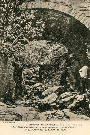 This vintage Catskills postcard depicts the historic stone arch bridge that marks the entrance to the Hell Hole at Platte Clove.