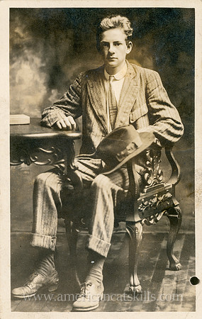 Otto Hillig undated portrait of a young man dressed in a suit, sitting in chair at a table.