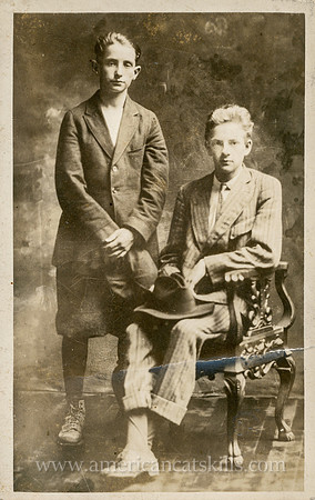 Otto Hillig undated portrait of two young men, one sitting, one standing, both in oversized suits.