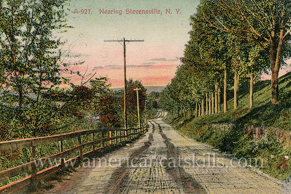 Vintage Catskills postcard by photographer Otto Hillig depicting an empty dirt country road as it approaches the hamlet of Stevensville (now Swan Lake) in Sullivan County, New York.