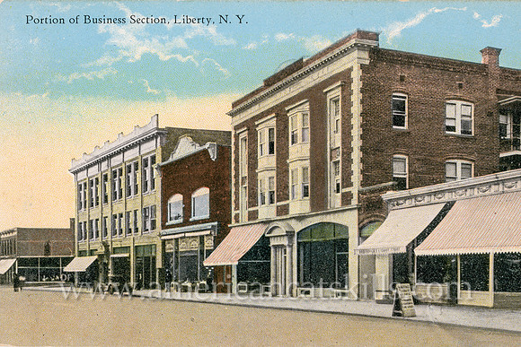 This vintage Catskills postcard by photographer Otto Hillig depicts the quiet business district at the village of Liberty in Sullivan County, New York.
