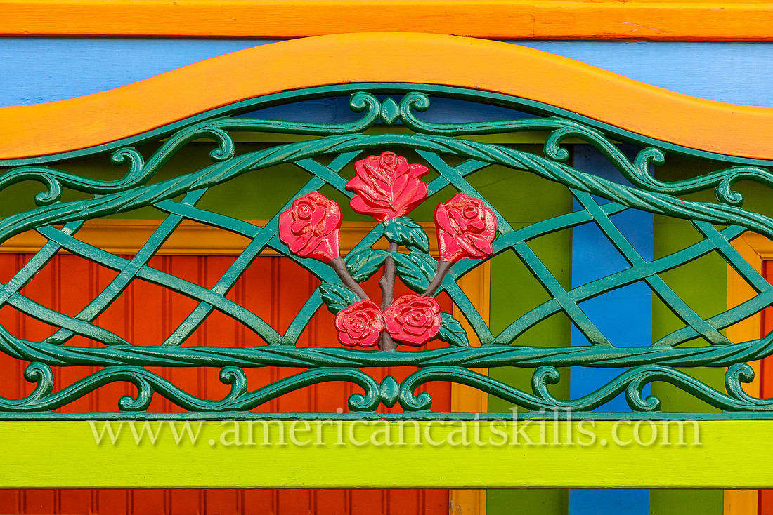 Photograph of a colorful bench with metal flowers in the northern Catskills village of Tannersville, New York.