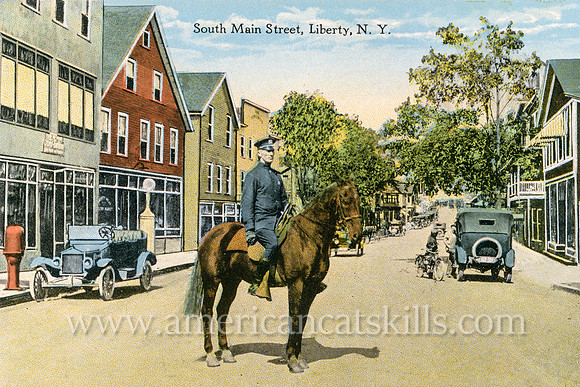 Vintage postcard from photographer Otto Hillig depicting Main Street in the village of Liberty in Sullivan County, New York.