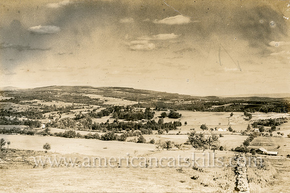 Rolling hills, farmhouses, stone walls characterize this beautiful photograph by well-known photographer Otto Hillig of Liberty, New York.