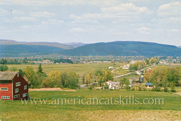 Vintage postcard by photographer Bob Wyer depicting the view from Masonville Mountain as it overlooks the village of Sidney in Delaware County, New York.